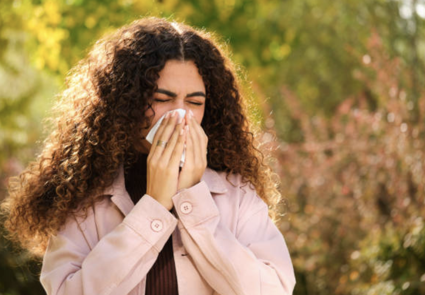 how spring allergies affect your mood woman blowing her nose